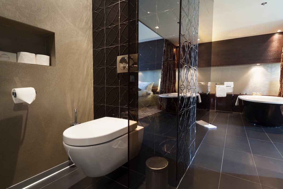High-end bathroom with floating toilet and black bathtub
