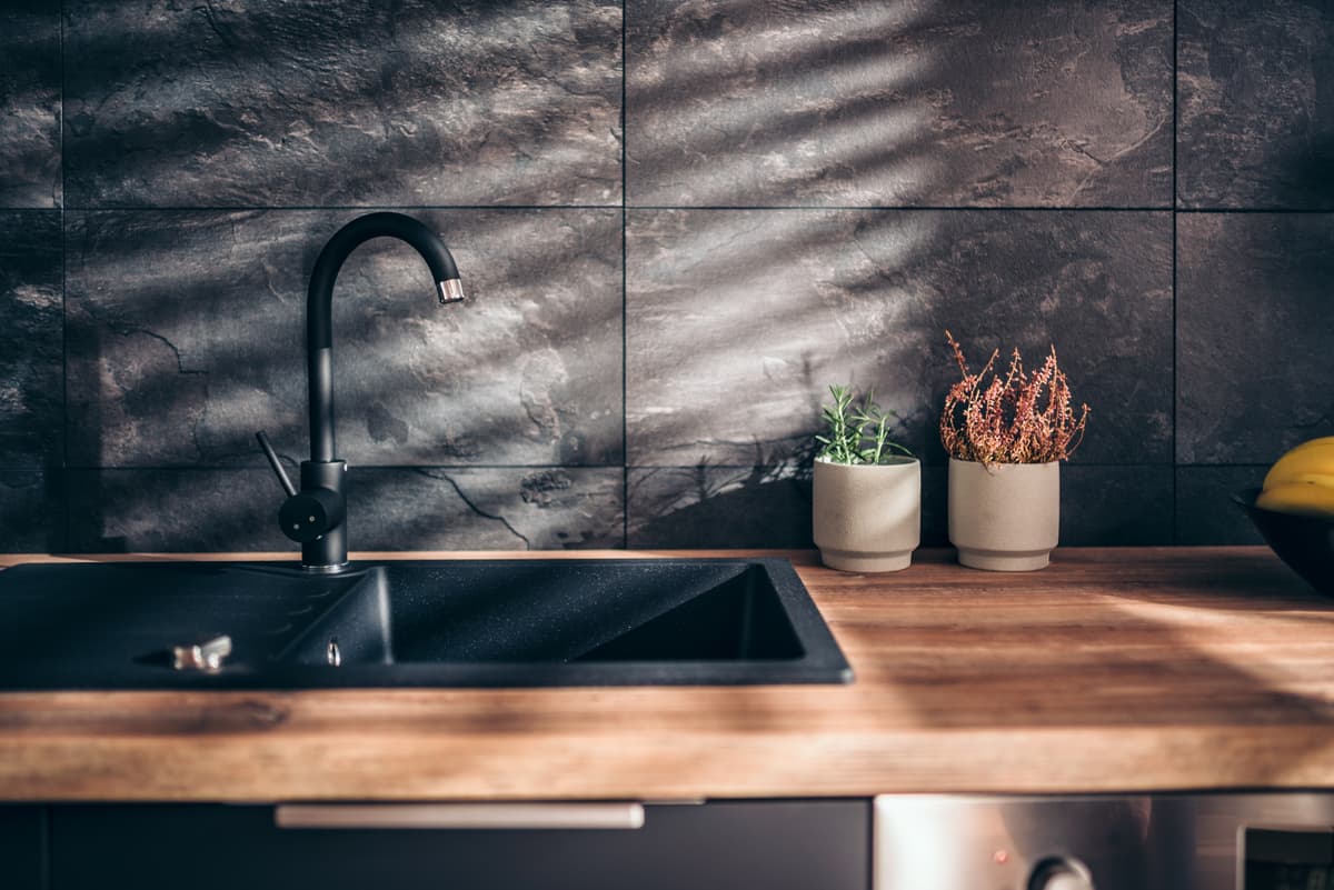 Modern kitchen sink with black faucet